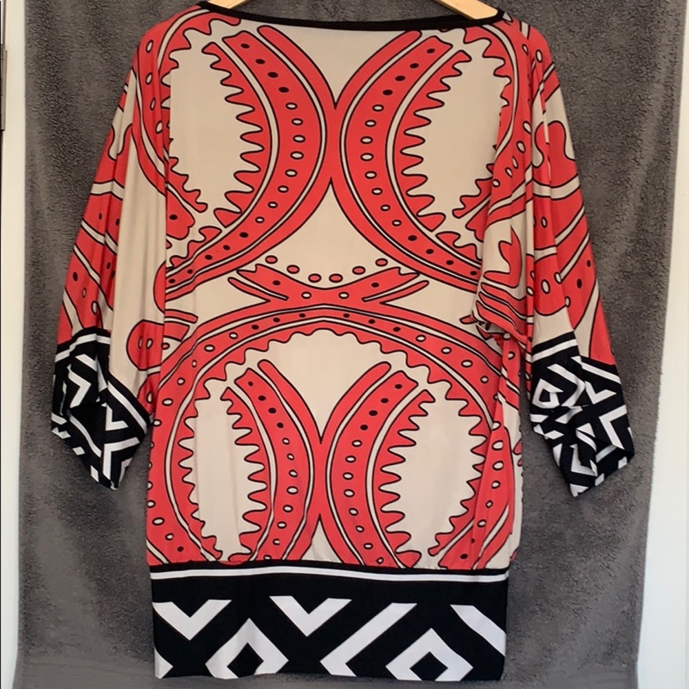 Coral and white print blouse.